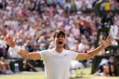 Carlos Alcaraz celebrates after defeating Novak Djokovic